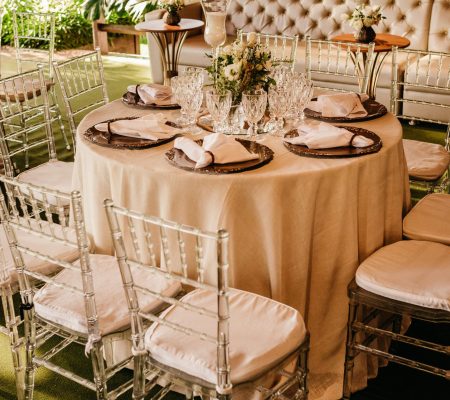 Beautifully arranged outdoor dining table set for an elegant garden event.