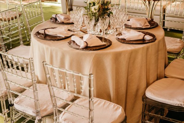 Beautifully arranged outdoor dining table set for an elegant garden event.